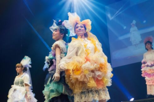 ドレスアップした美容科の学生がステージ上でポーズをとっている様子